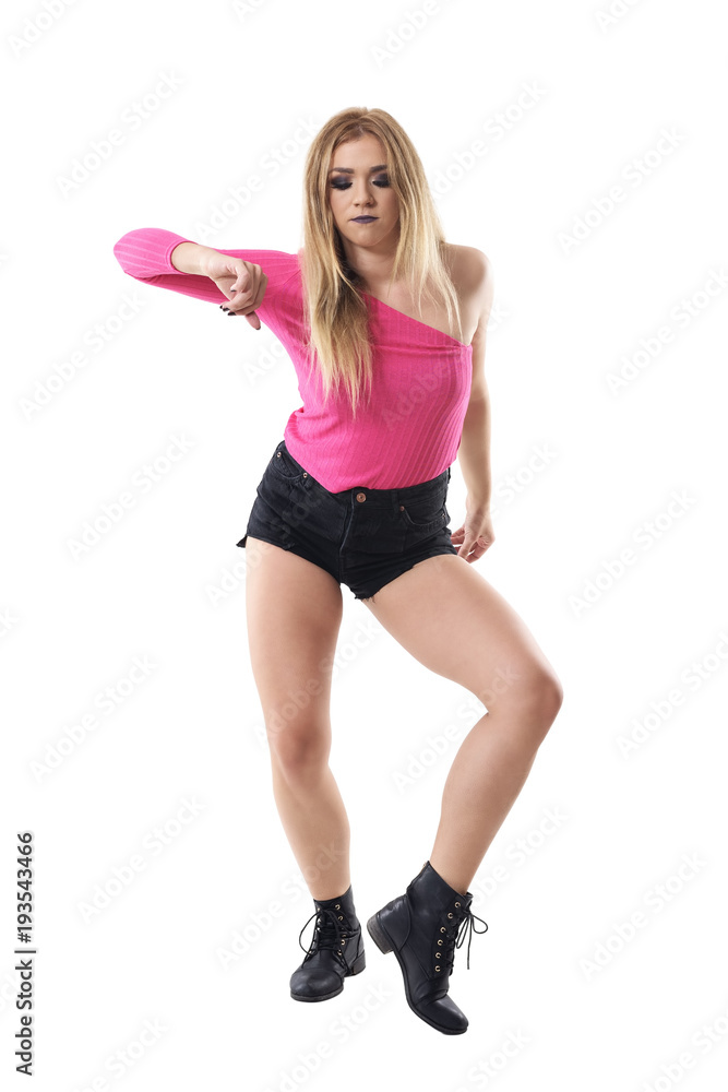Woman dancing jazz dance in short and pink one shoulder top. Full body length portrait isolated on white studio background. Woman dancing jazz dance in short and pink one shoulder top. Full body length portrait isolated on white studio background.