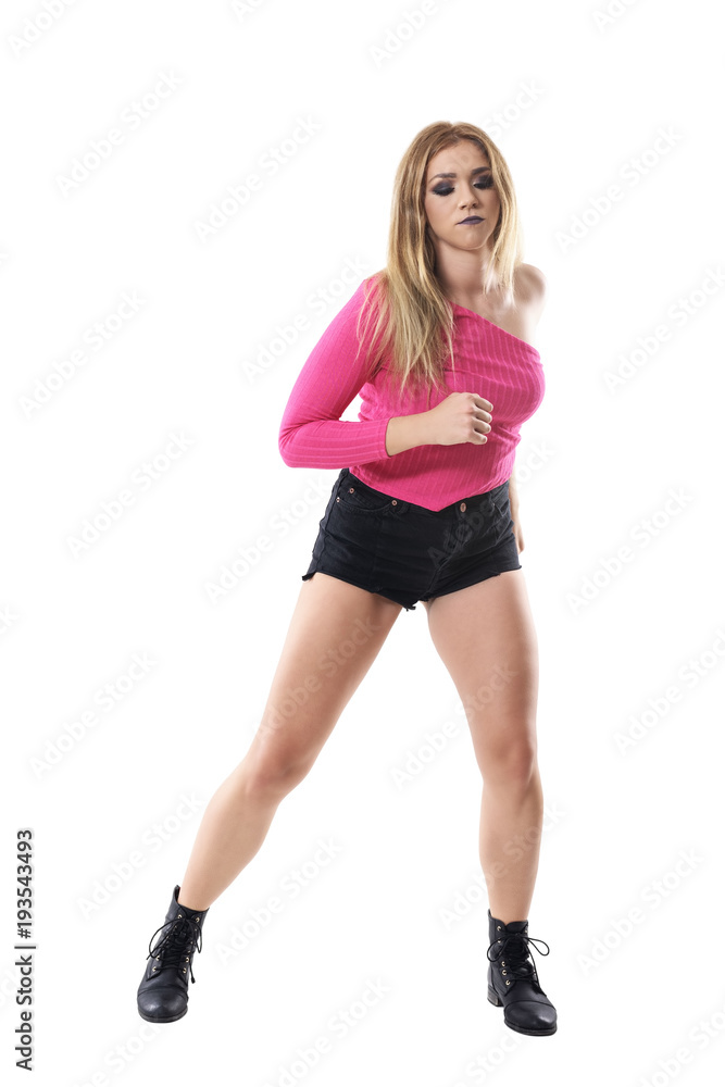 Female jazz dancer in pink one sleeve off shoulder shirt dancing and looking down. Full body length portrait isolated on white studio background. Female jazz dancer in pink one sleeve off shoulder shirt dancing and looking down. Full body length portrait isolated on white studio background.