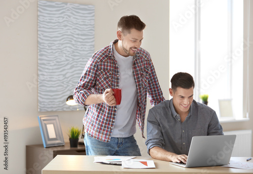 Young men with laptop indoors
