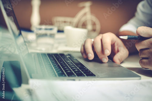 Close up businessman using laptop.