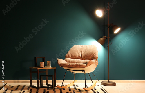 Trendy armchair with lamp a...