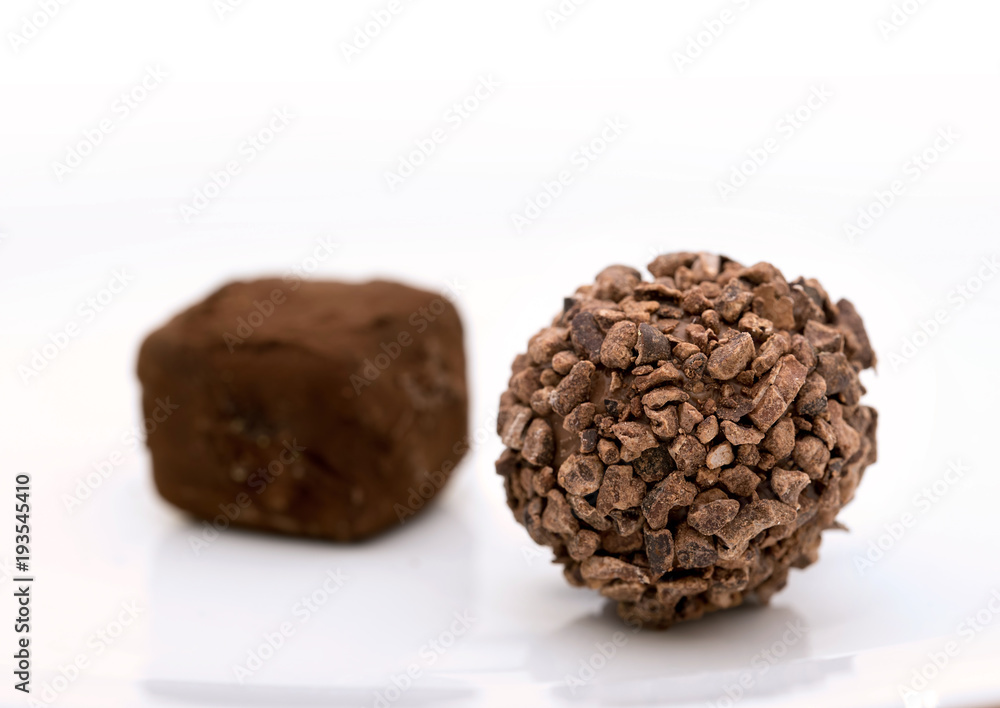 Closeup photo of chocolate bonbon on white background Closeup photo of chocolate bonbon on white background