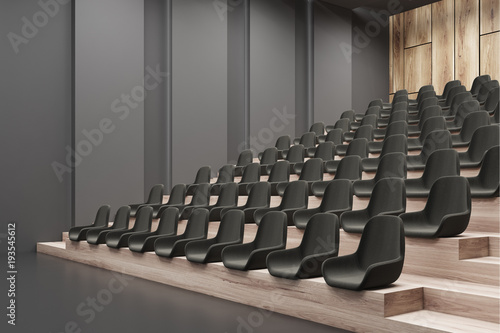 Cinema interior corner, black chairs, gray