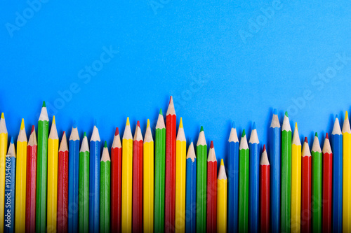 Colored pencils background.Color pencils isolated on white background.Close up. Many different colored pencils on blue background.Colorful pencil .Colorfull Macro shot of color pile pencil nibs