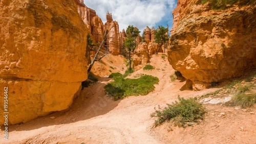 Video in motion along the trail. Walk along the path.Spectacular view at the yellow cliffs. Nature video. Amazing mountain landscape. Bryce Canyon National Park. Utah.USA. 4K, 3840*2160, high bit rate