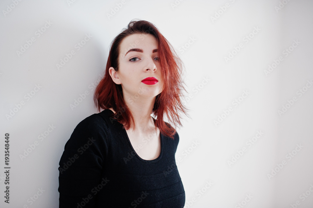 Red haired girl on black dress tunic against white wall at empty room. Red haired girl on black dress tunic against white wall at empty room.