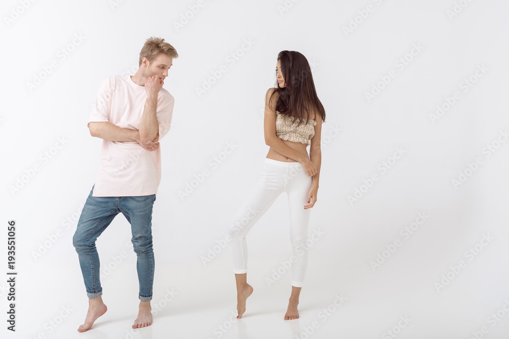 Fashionable man and woman posing in studio Fashionable man and woman posing in studio