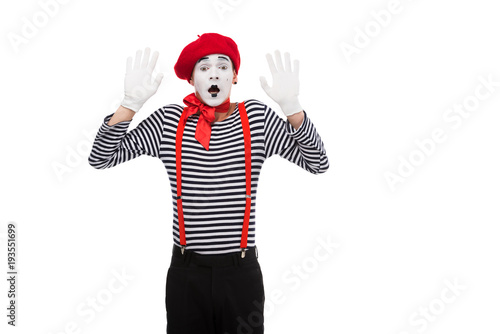 Vászonkép shocked mime standing with hands up isolated on white