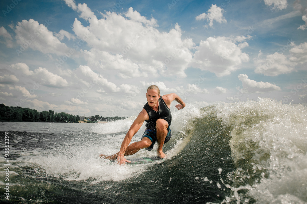 © fesenko - Sportsman going wakeboarding at the river