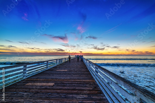 Fototapeta Naklejka Na Ścianę i Meble -  People in Pacific Beach pier at sunset