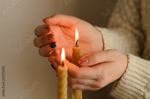 Wax candle in a woman's hand