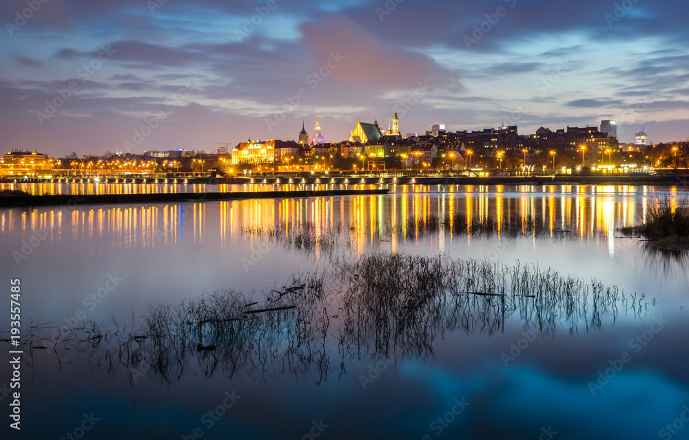 Night view on the old town and Vistula river in Warsaw, Poland