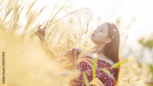 Принти на полотні Beautiful young brunette woman wearing a red tube dress in autumn park