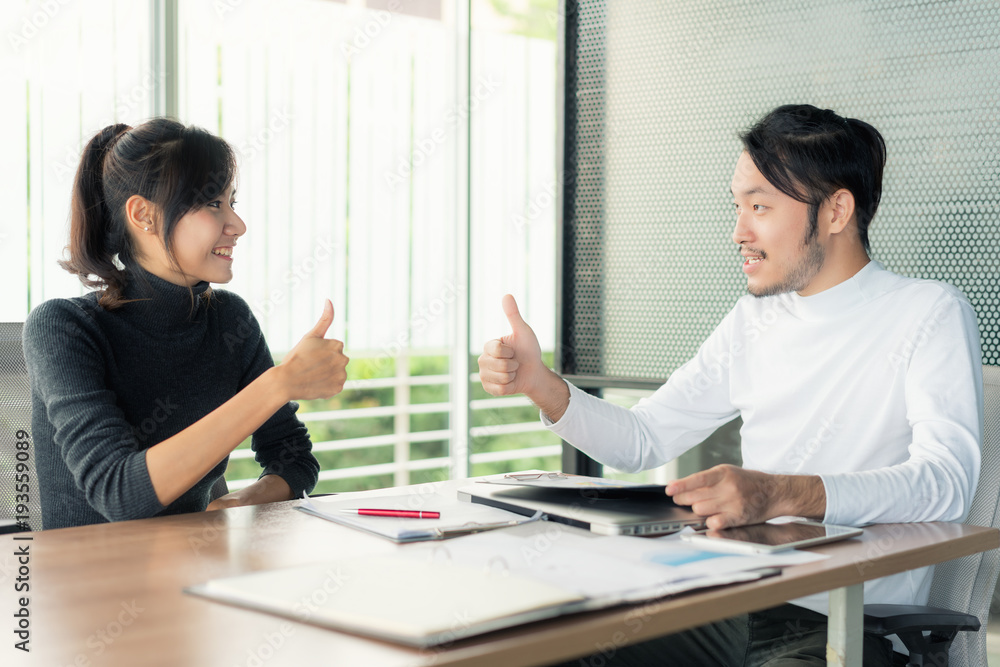 Asian business team partner in business office thump up after successful business deal. Asian business team partner in business office thump up after successful business deal.