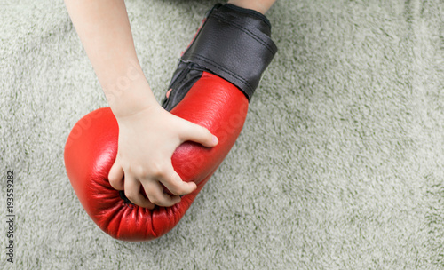 Boxing gloves in the hands of a little boy.