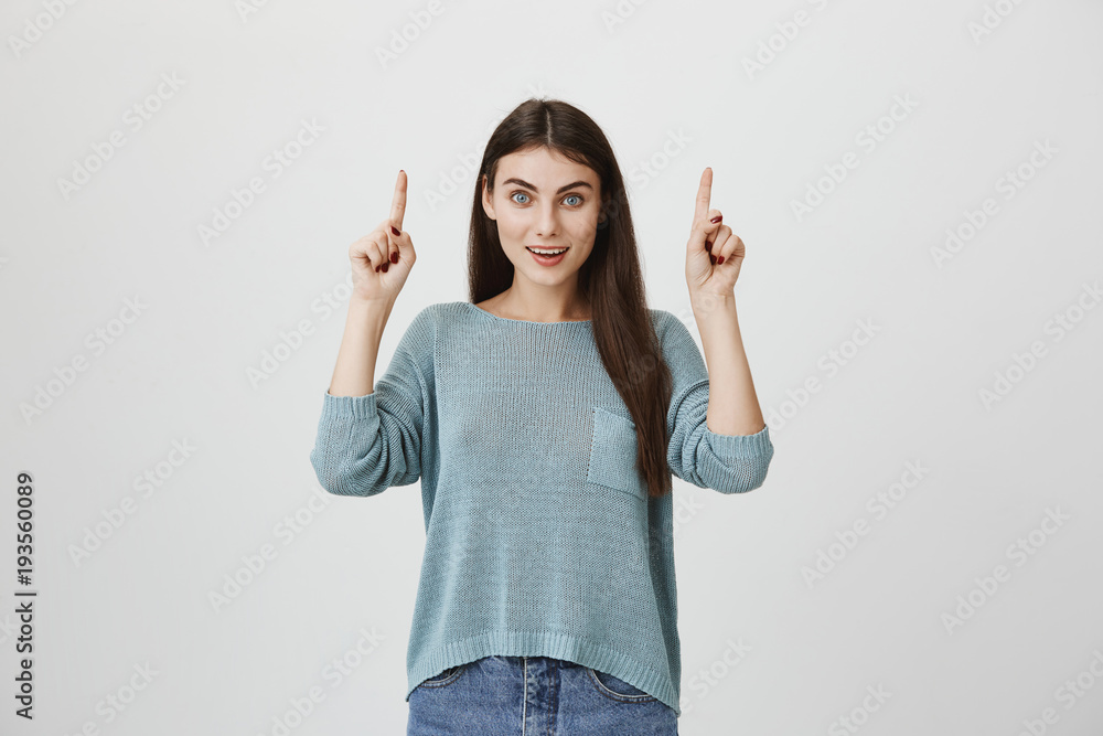 Cute brunette with beautiful eyes and charming smile pointing up with both index fingers. Girlfriend on picnic saw air balloon and amazed with size of it. Mother shows squirrel on tree Cute brunette with beautiful eyes and charming smile pointing up with both index fingers. Girlfriend on picnic saw air balloon and amazed with size of it. Mother shows squirrel on tree