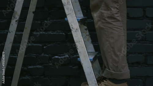 Shot of Painter Climbed the Stairs and Took a Jar With Black Paint