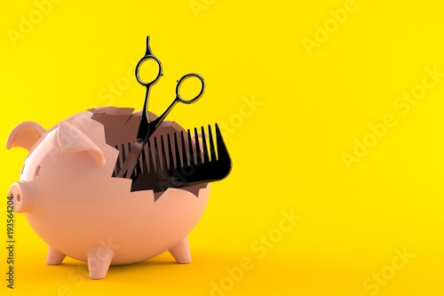 Obraz na płótnie Barber scissors with comber inside piggy bank