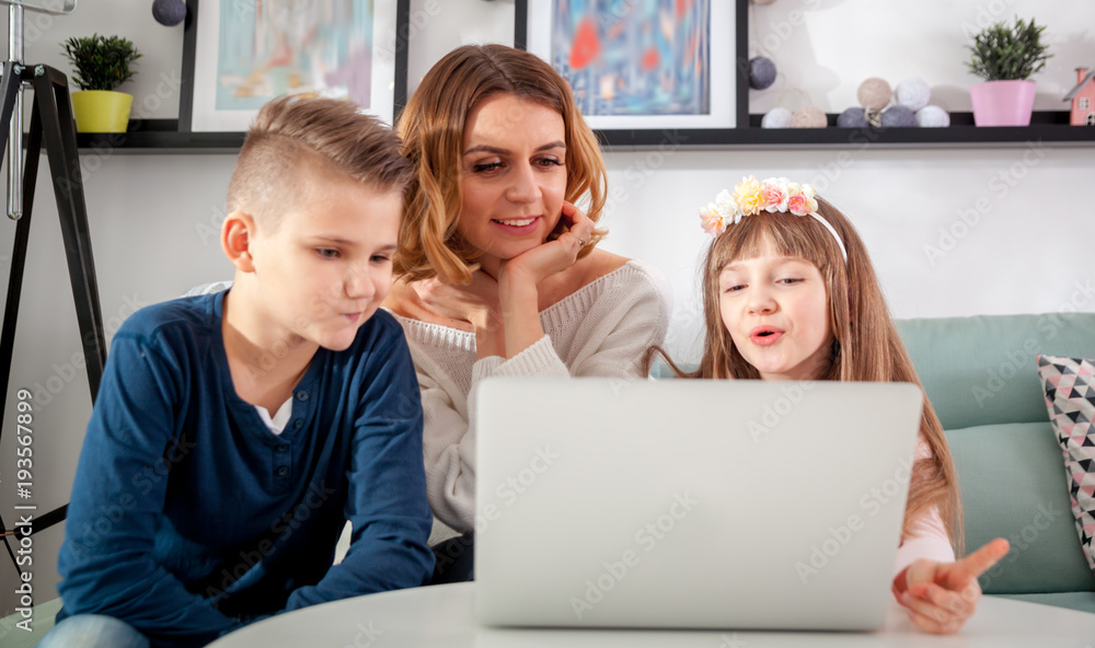 Happy family using together pc laptop at home Happy family using together pc laptop at home
