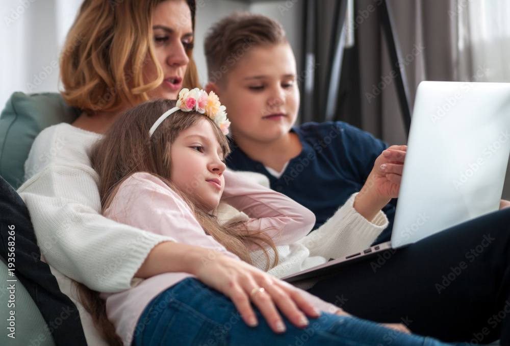 Happy family using together pc laptop at home