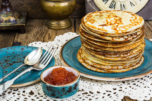 Fresh delicious pancakes with red caviar