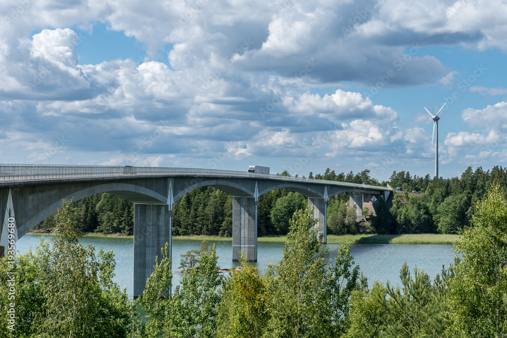 Traffic crossing a bridge over water in sunshine Traffic crossing a bridge over water in sunshine