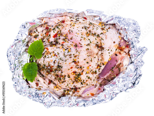 Piece of turkey in foil for baking photo