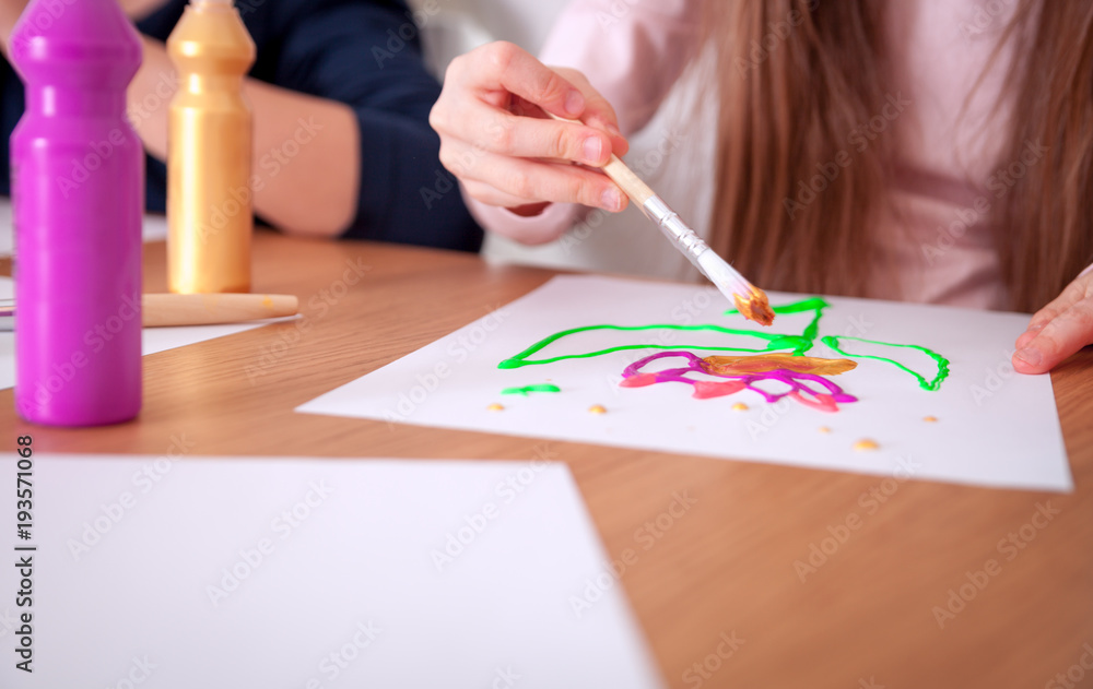 Children painting on paper at home close up Children painting on paper at home close up