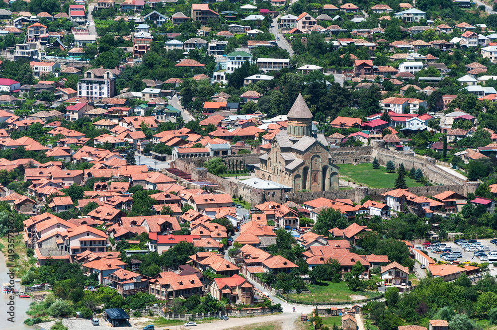 Panoramic beautiful aerial view of Mtskheta with the rivers Kura and Aragvi, Svetitskhoveli Cathedral and castle complex in summer day in Mtskheta, Georgia