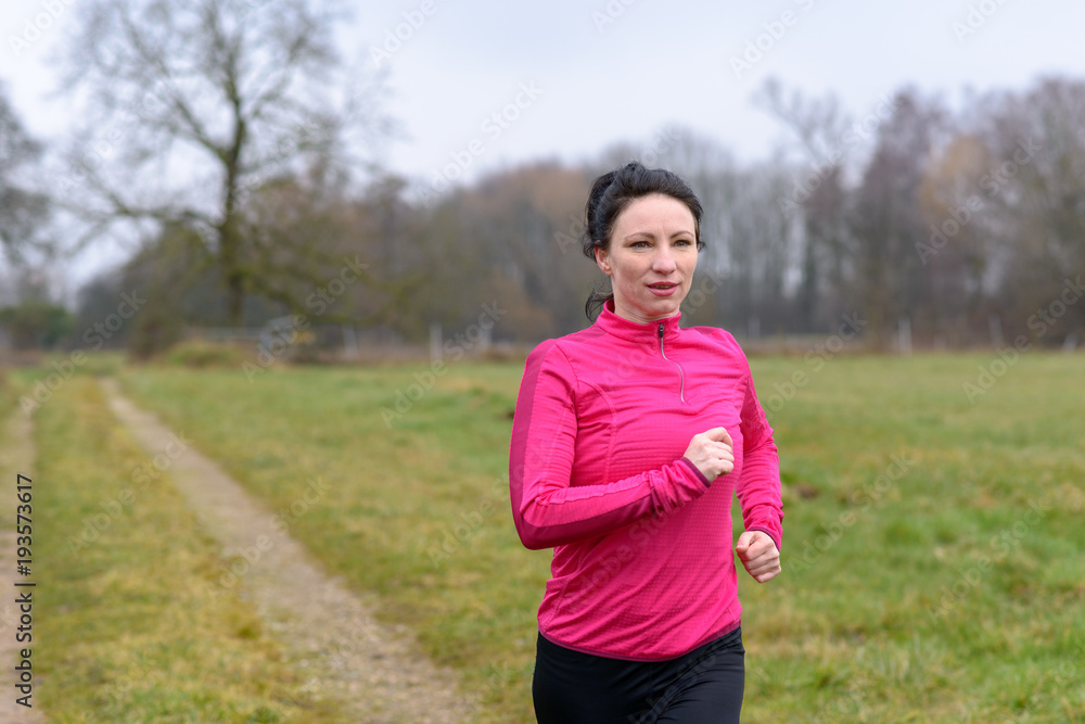 Fit woman jogging towards the camera Fit woman jogging towards the camera