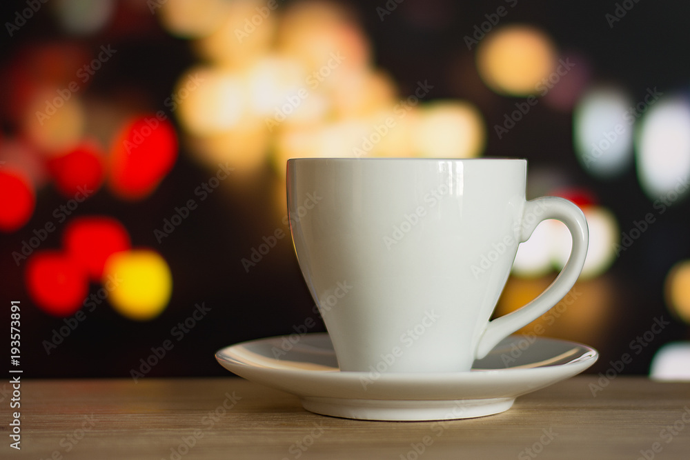 cup of coffee on wooden table with defocus bokeh of coffee shop background. Image with soft focus and blurred background. cup of coffee on wooden table with defocus bokeh of coffee shop background. Image with soft focus and blurred background.
