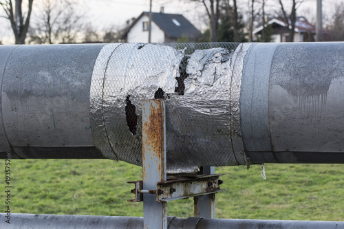 Damaged and provisionally repaired hot water pipe cover. photo