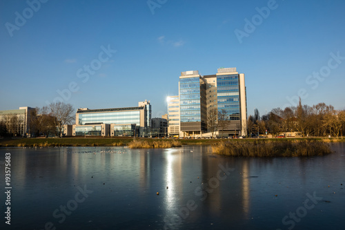Pond Sluzewiecki and office building at winter in Mokotow district, Warsaw, Poland