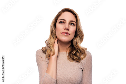Attractive blond young woman. Portrait of a beautiful woman on a white background. © Denis Rozhnovsky