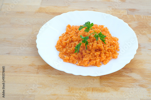 minced orange carrot and parsley in a dish