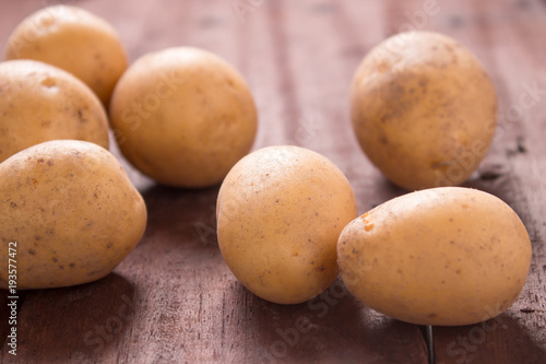 Potato is on rustic wooden table