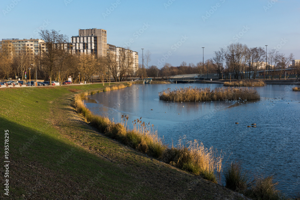 Pond Sluzewiecki and office building at winter in Mokotow district, Warsaw, Poland