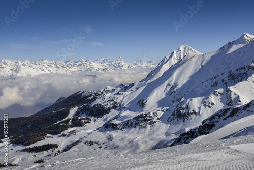 Panoramic view of wide and groomed ski piste in resort of Pila in Valle d'Aosta, Italy during winter © Alexandre Rotenberg
