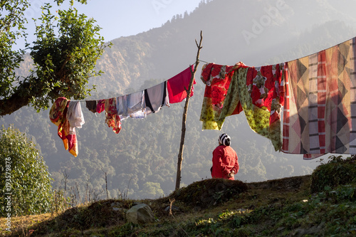 Rear view of woman and laundry line, Annapurna Circuit, en route to Ghorepani, Nepal photo