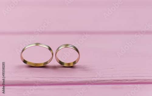 Two wedding rings. The male is flattened. The concept of severing relations, suppressing the husband's wife.