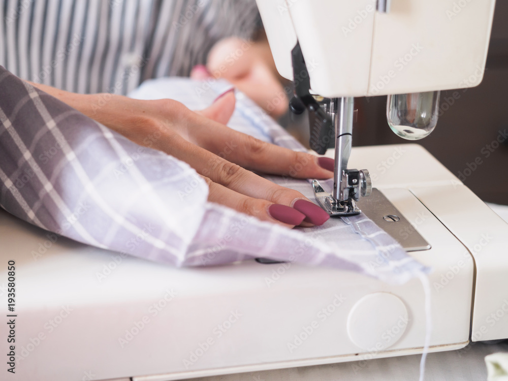 Girl working on sewing machine with textile napkins