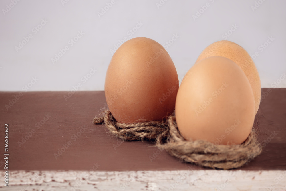 Three eggs on a brown wooden background. Easter concept Three eggs on a brown wooden background. Easter concept