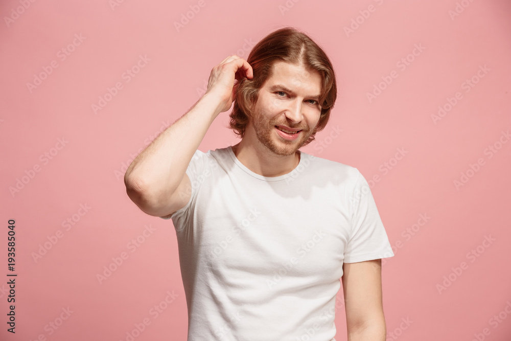 The happy business man standing and smiling against pink background. The happy business man standing and smiling against pink background.