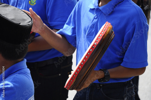 Boy plays Kompang during Malay wedding ceremony. Kompang is a Malay traditional drums that usually played during the traditional Malay wedding photo