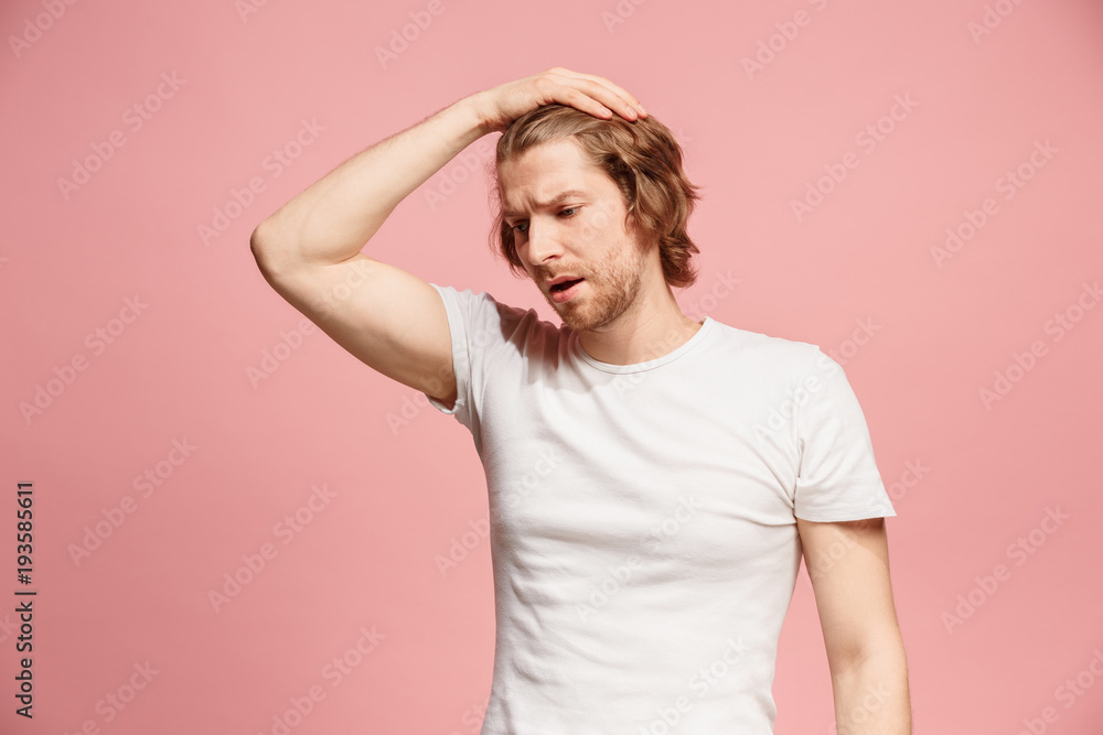 Beautiful man looking suprised and bewildered isolated on pink Beautiful man looking suprised and bewildered isolated on pink