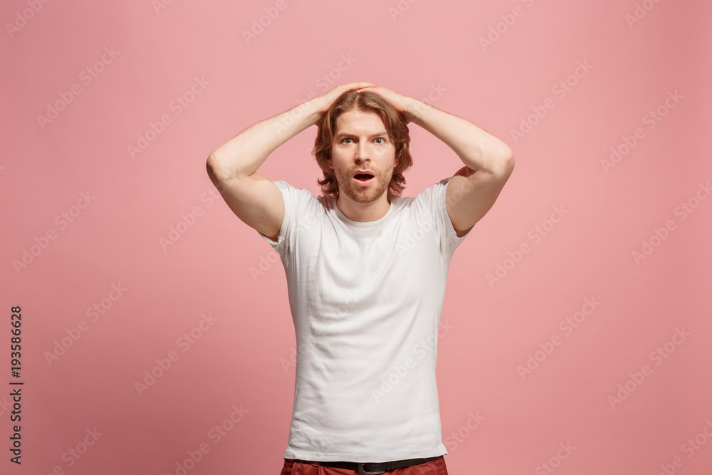 Beautiful man looking suprised isolated on pink Beautiful man looking suprised isolated on pink