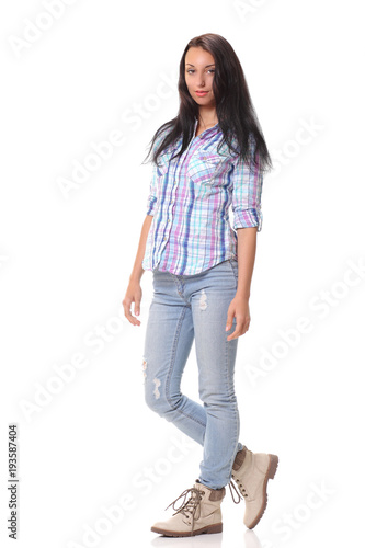 Picture of a young casual woman standing on white