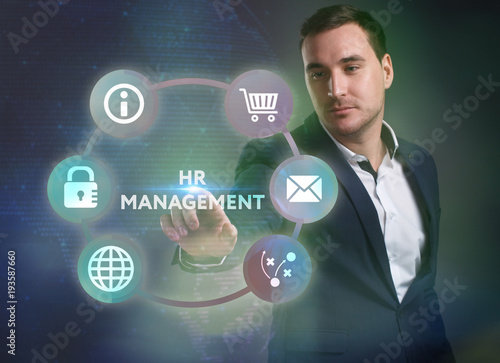 Business, Technology, Internet and network concept. Young businessman working on a virtual screen of the future and sees the inscription: HR management
