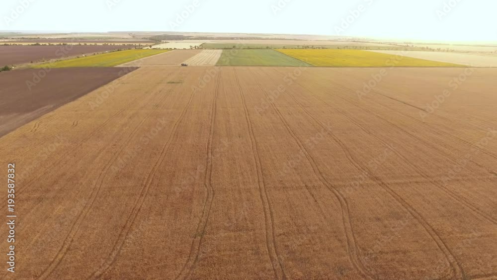 An encouraging bird`s eye view of an agro field in Ukraine on a sunny day. It is covered with square looking pieces of farming land. An encouraging bird`s eye view of an agro field in Ukraine on a sunny day. It is covered with square looking pieces of farming land.
