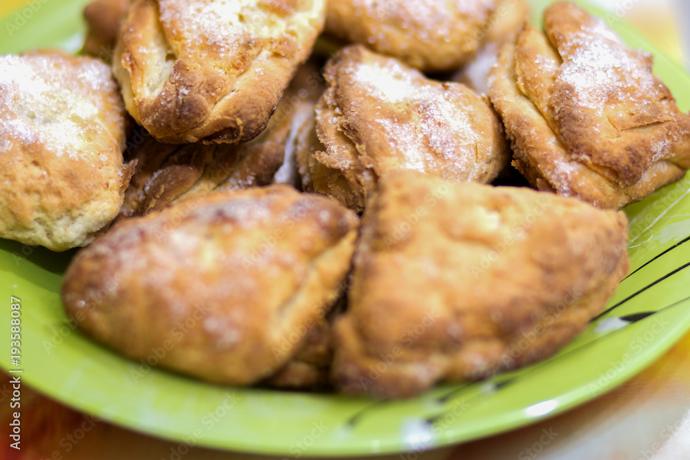 Biscuit cookies with sugar, cooked, lies in a plate on the table Biscuit cookies with sugar, cooked, lies in a plate on the table